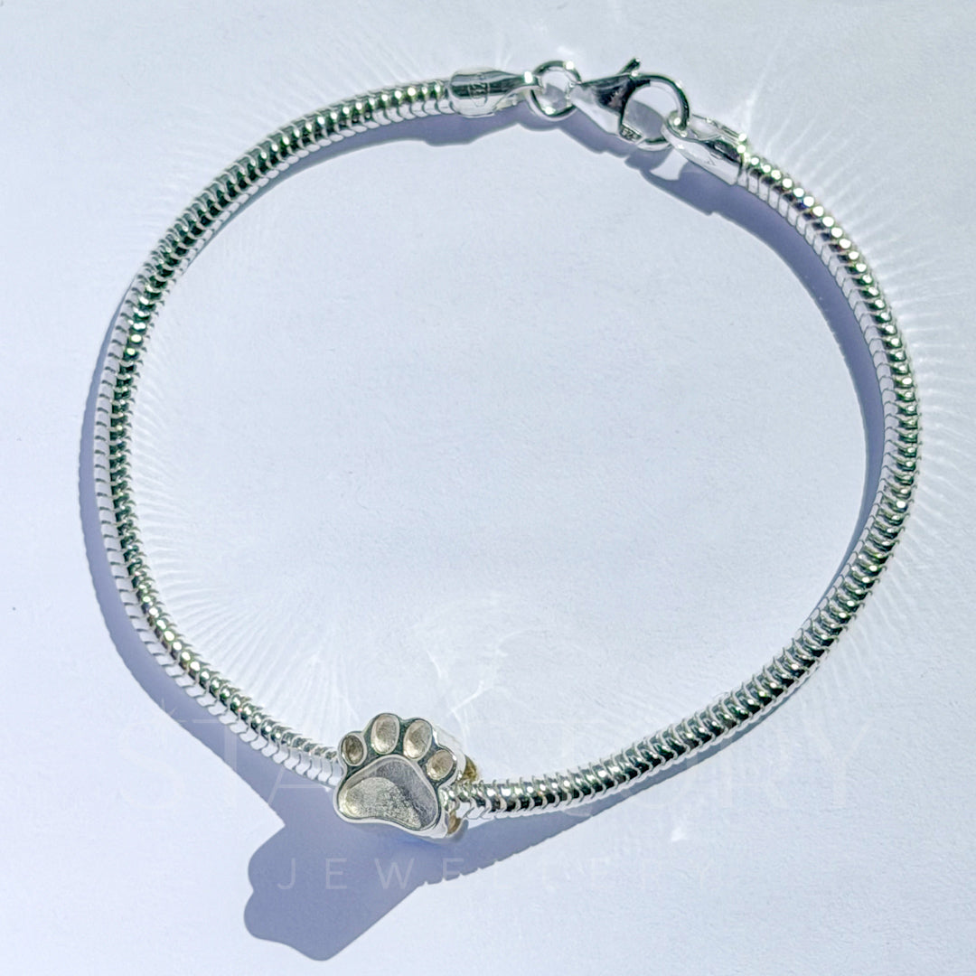 Pawprint memorial charm and bracelet in sterling silver for ash, hair and fur inclusions. 